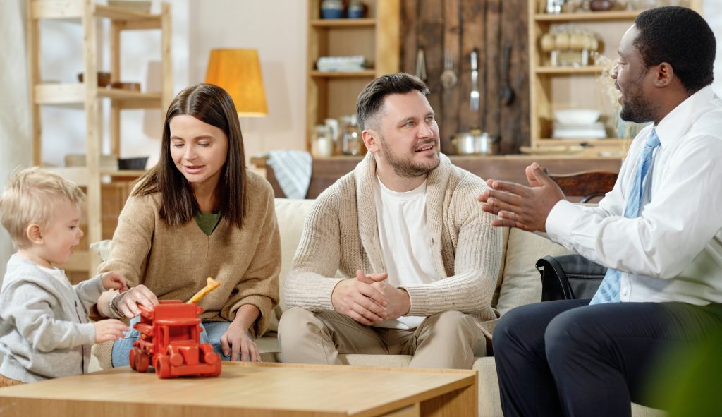 Young family having consultation with real estate agent